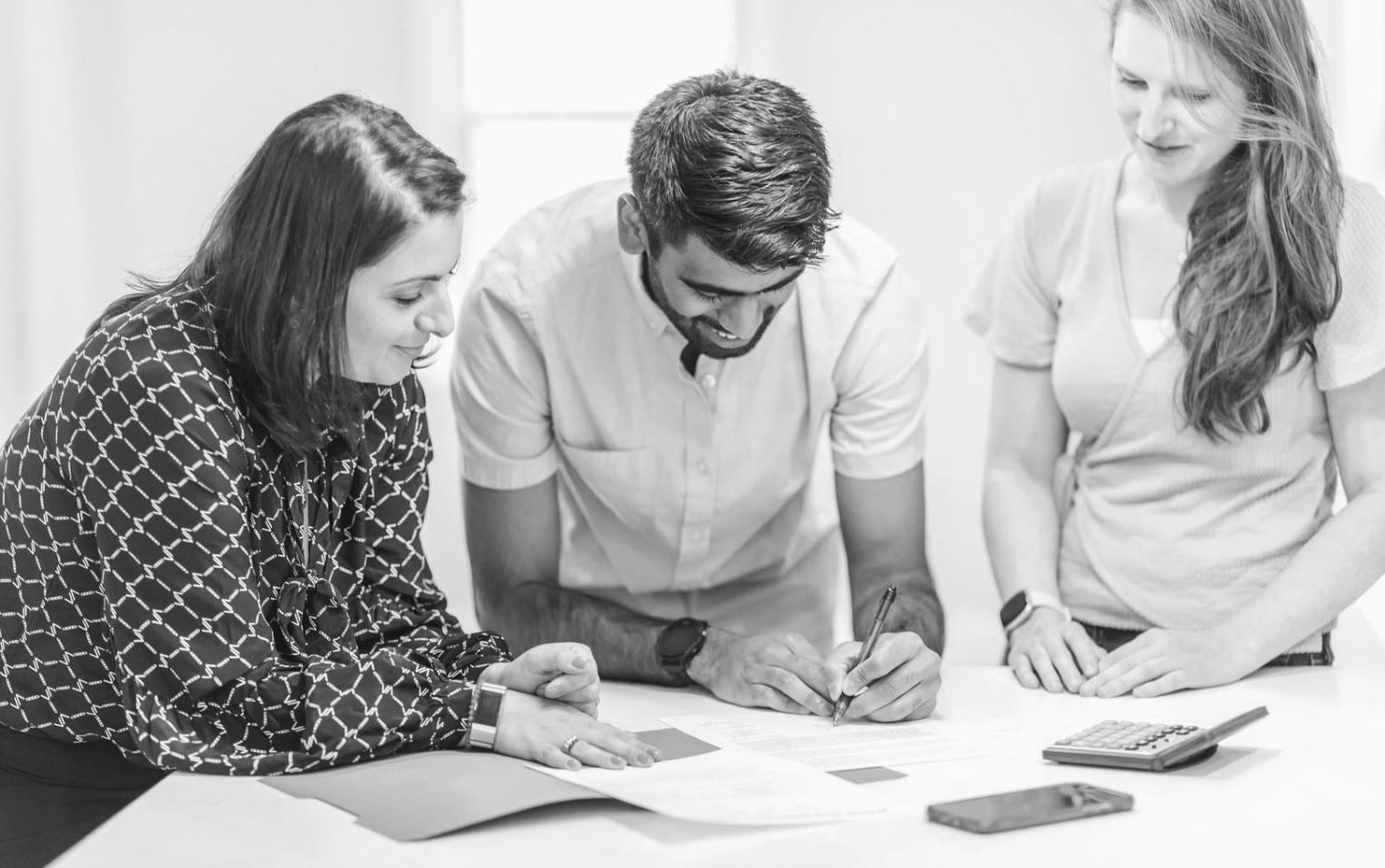 Professional setting with people reviewing service information